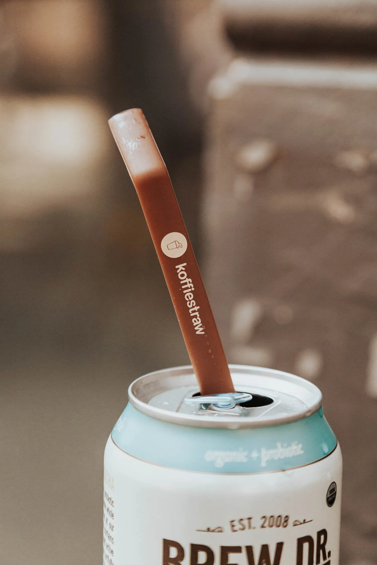 4-Pack of KoffieStraw 10": Pink, Black, Mocha, Surf with stainless steel cleaning brush in a home compostable packaging